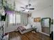 Bright bedroom featuring a twin bed, laminate wood flooring, and decorative lighting at 14703 W Hillside St, Goodyear, AZ 85395