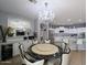 Bright dining space with a round table, chandelier, and built-in bar area, flowing into the kitchen at 14703 W Hillside St, Goodyear, AZ 85395