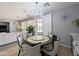 Elegant dining area features a stylish round table, modern chandelier, and access to the outdoor space at 14703 W Hillside St, Goodyear, AZ 85395
