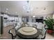 Open concept living area with a round dining table, connecting to the kitchen and living room spaces at 14703 W Hillside St, Goodyear, AZ 85395