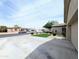 Spacious home featuring an extra-long driveway, desert landscaping, and a well-maintained lawn at 14703 W Hillside St, Goodyear, AZ 85395