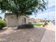 Charming single-story home featuring a well-maintained yard with desert landscaping and a spacious driveway at 14703 W Hillside St, Goodyear, AZ 85395