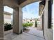 Home's covered entryway offers a view of the well-maintained lawn and desert landscaping at 14703 W Hillside St, Goodyear, AZ 85395