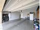 A clean and organized garage featuring a water heater and ample space for storage and projects at 14703 W Hillside St, Goodyear, AZ 85395