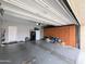 Well-maintained garage with a white door and wall-to-wall cabinets for optimal storage solutions at 14703 W Hillside St, Goodyear, AZ 85395