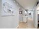 Hallway featuring tile floors, and white cabinets that enhance the storage and add style to the home's interior at 14703 W Hillside St, Goodyear, AZ 85395