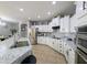 A kitchen with white cabinets and granite countertops, as well as stainless steel appliances at 14703 W Hillside St, Goodyear, AZ 85395