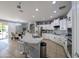 An open-concept kitchen with white cabinets, granite countertops, and stainless steel appliances at 14703 W Hillside St, Goodyear, AZ 85395