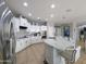 Bright kitchen with white cabinets, granite countertops, and stainless steel appliances at 14703 W Hillside St, Goodyear, AZ 85395