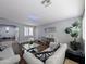 Living room featuring hardwood floors, gray couches, mirrored decor, a gray paint scheme, and plantation shutters at 14703 W Hillside St, Goodyear, AZ 85395