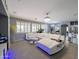 Open living space with a large white sectional sofa, modern lighting, and seamless flow to the dining area at 14703 W Hillside St, Goodyear, AZ 85395