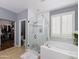 Main bathroom featuring a large tub, a shower, and a separate toilet room at 14703 W Hillside St, Goodyear, AZ 85395