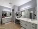 Spacious main bathroom boasts dual vanities, soaking tub, and glass shower at 14703 W Hillside St, Goodyear, AZ 85395