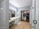 This main bathroom features a double sink vanity, shower, and walk-in closet at 14703 W Hillside St, Goodyear, AZ 85395