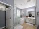 The main bathroom boasts a glass shower, a tub, and neutral colors at 14703 W Hillside St, Goodyear, AZ 85395