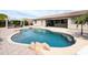 Inviting backyard pool with rock features, pergola, and a spacious patio for outdoor entertaining at 14703 W Hillside St, Goodyear, AZ 85395