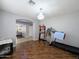 Workout room featuring wood floors, exercise equipment, a dog crate, and a view into the living room at 14703 W Hillside St, Goodyear, AZ 85395