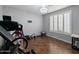 Workout room with wood floors, plantation shutters, exercise equipment, and a chandelier at 14703 W Hillside St, Goodyear, AZ 85395