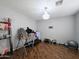 Workout room with wood floors, a chandelier, and exercise equipment including a treadmill and inversion table at 14703 W Hillside St, Goodyear, AZ 85395