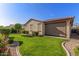 Well-maintained backyard with lush green grass, manicured landscaping, and a privacy screen for added seclusion at 16229 W Jenan Dr, Surprise, AZ 85379