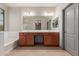 Well-lit bathroom featuring soaking tub, glass shower, double sink vanity and neutral color palette at 16229 W Jenan Dr, Surprise, AZ 85379