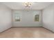 Bright bedroom with tiled floors, neutral paint, and windows providing natural light at 16229 W Jenan Dr, Surprise, AZ 85379
