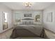 Inviting bedroom with soft gray accents, a large mirror, and bright windows at 16229 W Jenan Dr, Surprise, AZ 85379