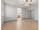 Spacious bedroom with neutral walls, tiled floors, ceiling fan, and access to a bathroom at 16229 W Jenan Dr, Surprise, AZ 85379