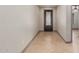 Bright foyer with tiled flooring, neutral walls, and a decorative front door to welcome you home at 16229 W Jenan Dr, Surprise, AZ 85379