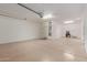 Spacious two car garage with painted floors and utility door at 16229 W Jenan Dr, Surprise, AZ 85379