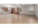 Open living room with kitchen view features tile flooring, natural light, and modern finishes at 16229 W Jenan Dr, Surprise, AZ 85379