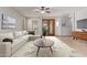 Bright living room featuring neutral walls, stylish furniture, and glass doors leading to the outdoor patio at 16229 W Jenan Dr, Surprise, AZ 85379