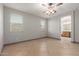 Spacious main bedroom with ensuite bathroom, ceiling fan, and plenty of natural light at 16229 W Jenan Dr, Surprise, AZ 85379