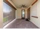 Covered outdoor patio with a ceiling fan and shade screen, perfect for relaxing and entertaining guests at 16229 W Jenan Dr, Surprise, AZ 85379