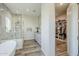 Bathroom with marble shower and adjacent walk-in closet at 17324 E Quail Track Rd, Rio Verde, AZ 85263