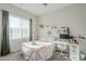Bedroom with pink accents, large window, desk, and soft textures at 17324 E Quail Track Rd, Rio Verde, AZ 85263