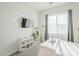 Bedroom featuring a wall mounted TV, shelving, and a large window at 17324 E Quail Track Rd, Rio Verde, AZ 85263