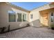Welcoming courtyard with pavers and natural light leading to a wood-finished front door at 17324 E Quail Track Rd, Rio Verde, AZ 85263