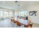 Open great room featuring dining table, wood floors, and stylish lighting with great views at 17324 E Quail Track Rd, Rio Verde, AZ 85263