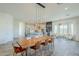 Spacious great room featuring dining area, stylish island seating, wood floors, and lots of light at 17324 E Quail Track Rd, Rio Verde, AZ 85263