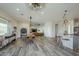 Open great room with stylish lighting, island seating, and hardwood-style floors, perfect for gatherings at 17324 E Quail Track Rd, Rio Verde, AZ 85263