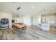 Open great room features hardwood floors, kitchen island with seating, and stylish light fixtures at 17324 E Quail Track Rd, Rio Verde, AZ 85263