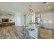Bright kitchen with a center island, bar seating, and an open floor plan at 17324 E Quail Track Rd, Rio Verde, AZ 85263