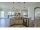 Modern kitchen island with stainless steel sink and views into the dining and living spaces at 17324 E Quail Track Rd, Rio Verde, AZ 85263