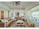 Inviting living room with a large sectional couch and modern decor, adjacent to the kitchen and outdoor space at 17324 E Quail Track Rd, Rio Verde, AZ 85263