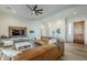 Cozy living room featuring leather sectional, modern decor, and hardwood floors and ceiling fan at 17324 E Quail Track Rd, Rio Verde, AZ 85263