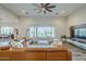 Comfortable living room with hardwood flooring, modern furnishings, and a large picture window overlooking the yard at 17324 E Quail Track Rd, Rio Verde, AZ 85263