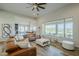 Large living room featuring a leather sectional, view of kitchen and backyard, and hardwood floors at 17324 E Quail Track Rd, Rio Verde, AZ 85263