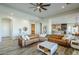 Inviting living room boasts a leather sectional, hardwood floors, and open layout to kitchen and dining area at 17324 E Quail Track Rd, Rio Verde, AZ 85263