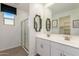 Bathroom features double sinks, modern fixtures, and a glass-enclosed shower at 17971 W Meadowbrook Ave, Goodyear, AZ 85395